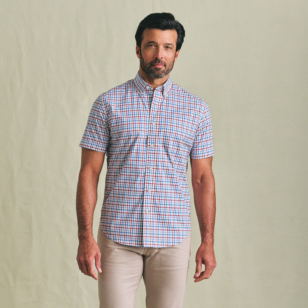 A man wears the Tom Beckbe Powell Performance Shirt (Short Sleeve) and beige pants, facing the camera against a plain backdrop.