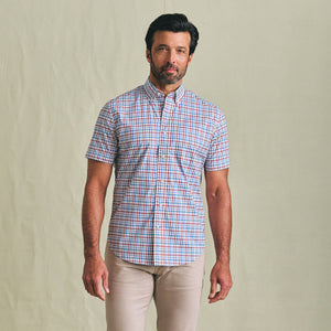 A man wears the Tom Beckbe Powell Performance Shirt (Short Sleeve) and beige pants, facing the camera against a plain backdrop.