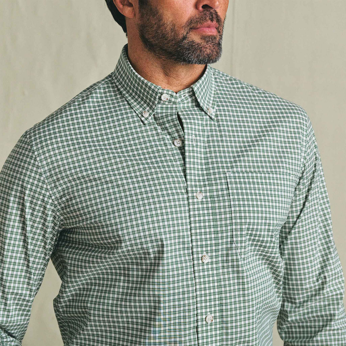 Man in Tom Beckbe Powell Performance Shirt, green/white check, UPF 30+, chest-up, facing slightly right.