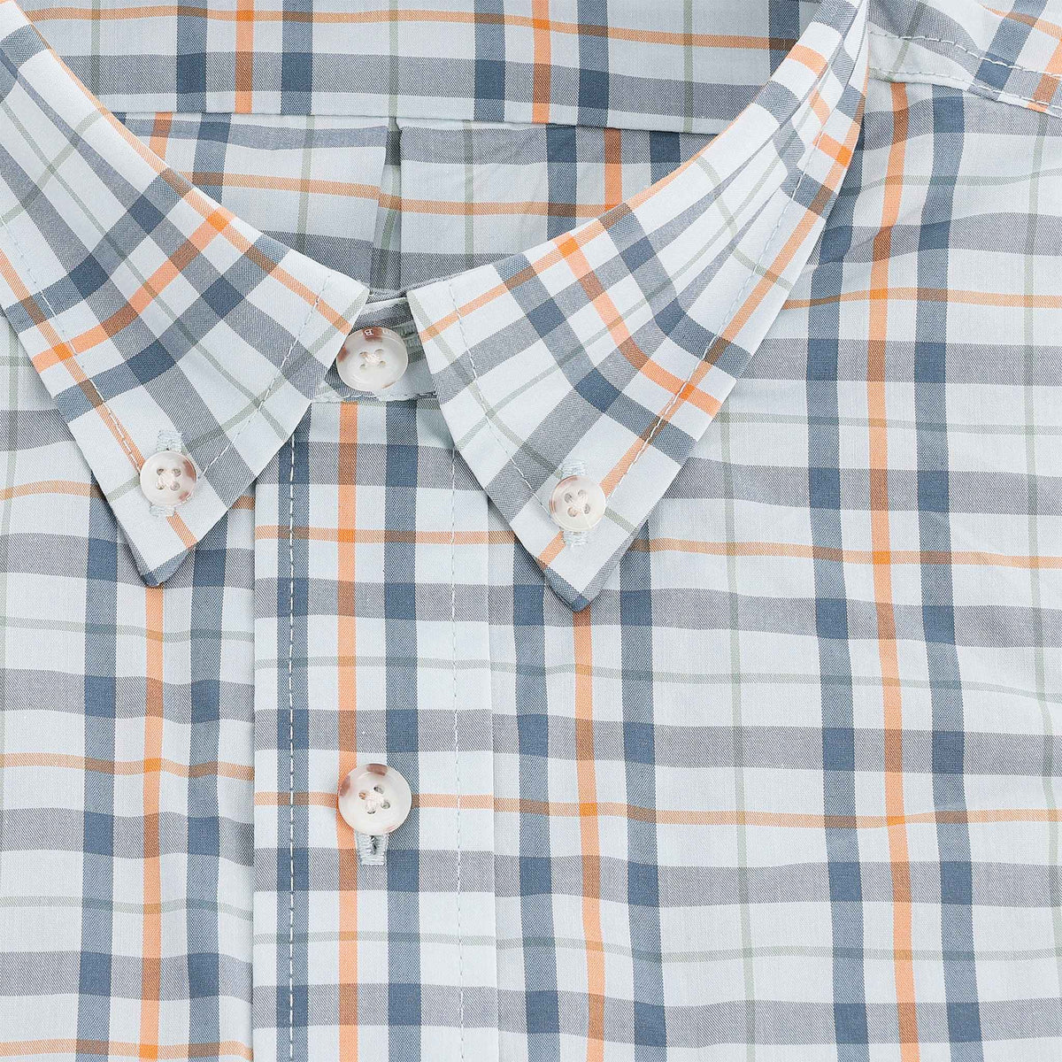 Close-up of the Tom Beckbe Powell Performance Shirt, short sleeve with blue, orange, and white plaid and white buttons.