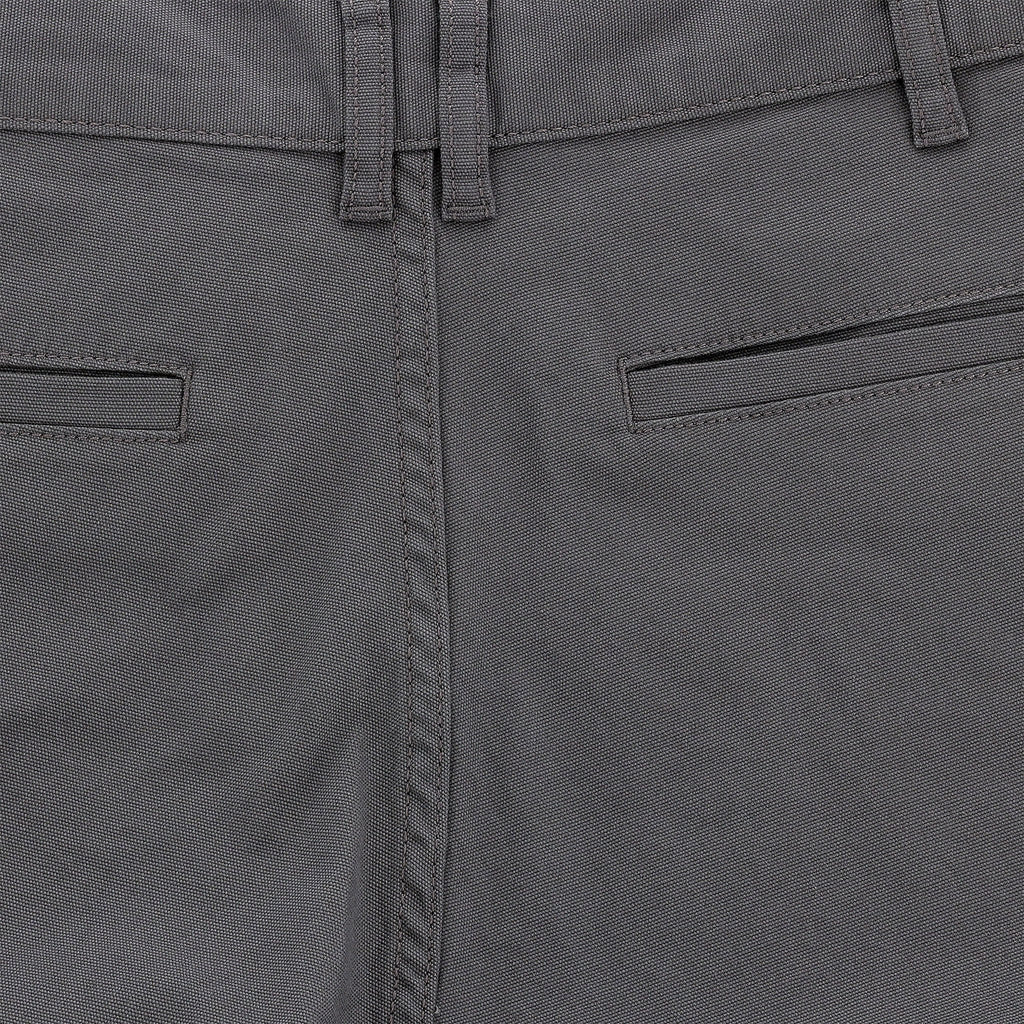 Close-up of mid-rise Tom Beckbe Reid Shorts with belt loops, welt pockets, and antique brass zip fly.