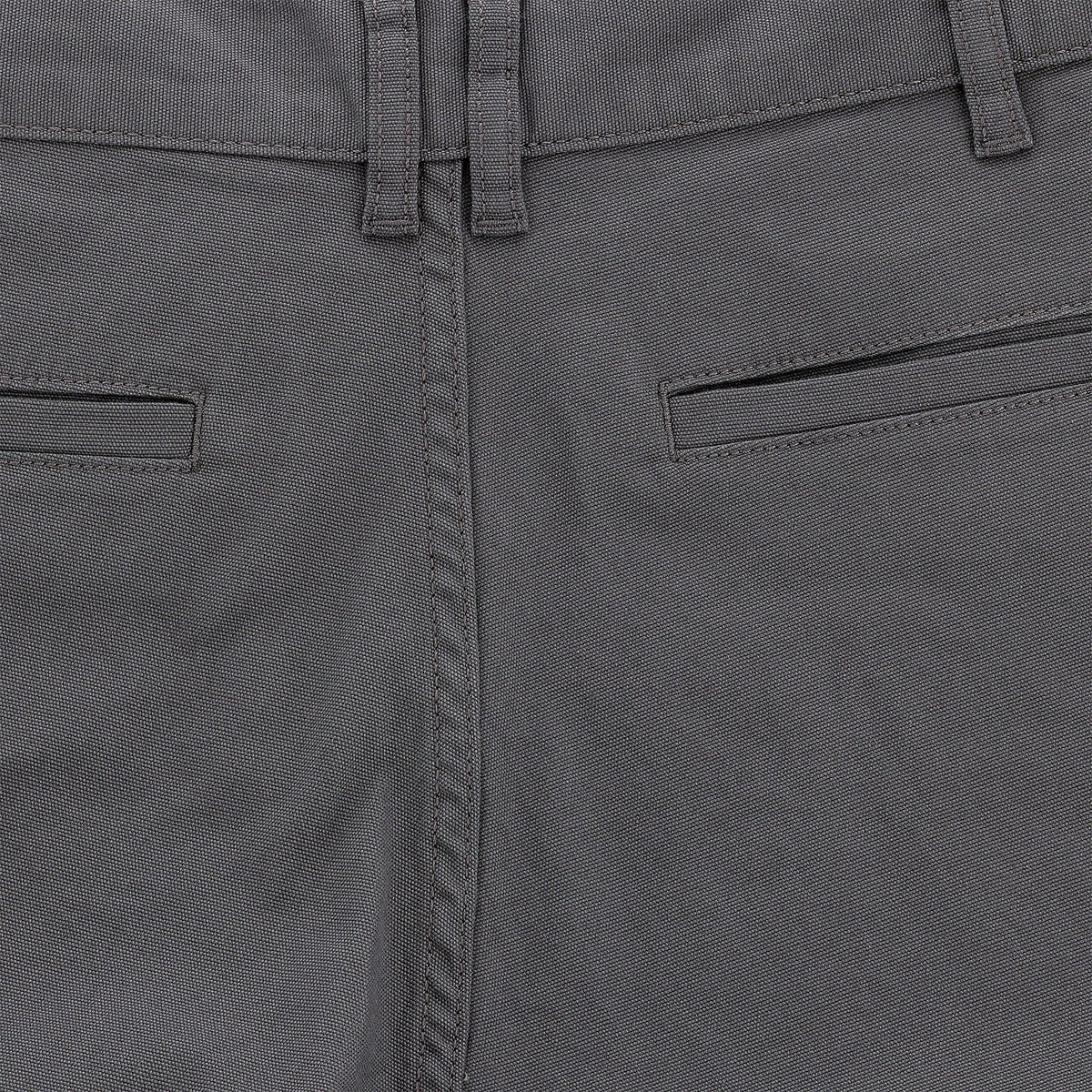 Close-up of mid-rise Tom Beckbe Reid Shorts with belt loops, welt pockets, and antique brass zip fly.