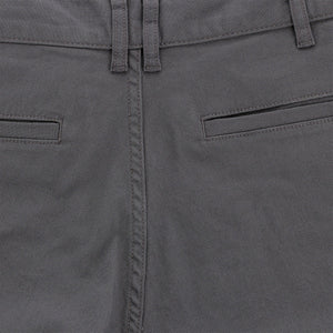 Close-up of mid-rise Tom Beckbe Reid Shorts with belt loops, welt pockets, and antique brass zip fly.