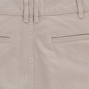 Close-up of Tom Beckbes Reid Short in beige, featuring mid-rise, double belt loops, horizontal pockets, detailed stitching.