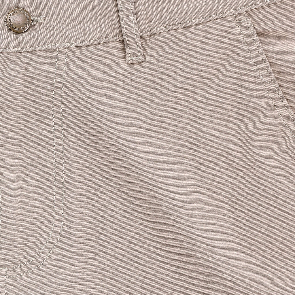 Close-up of Tom Beckbe Reid Short, light beige, mid-rise with button, belt loop, seam details, and antique brass zip fly.