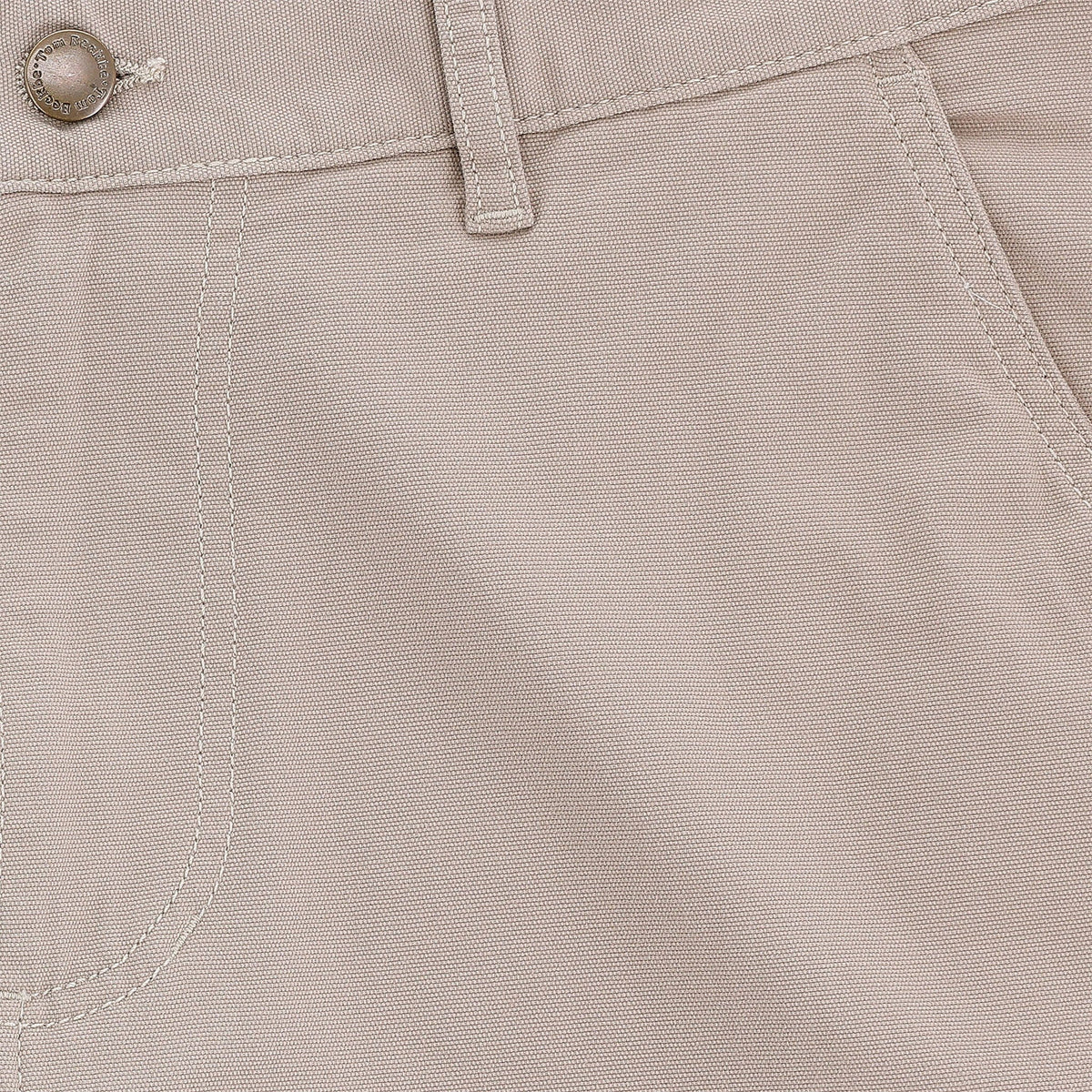 Close-up of Tom Beckbe Reid Short, light beige, mid-rise with button, belt loop, seam details, and antique brass zip fly.