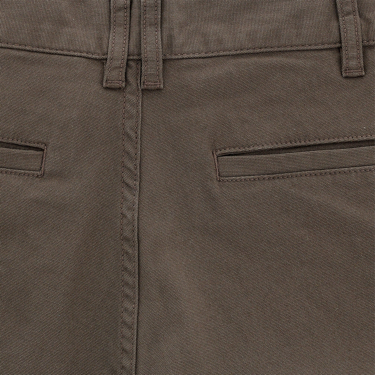Close-up of Tom Beckbes Reid Short in mid-rise brown with waistband, belt loops, brass zip fly, and two closed welt pockets.