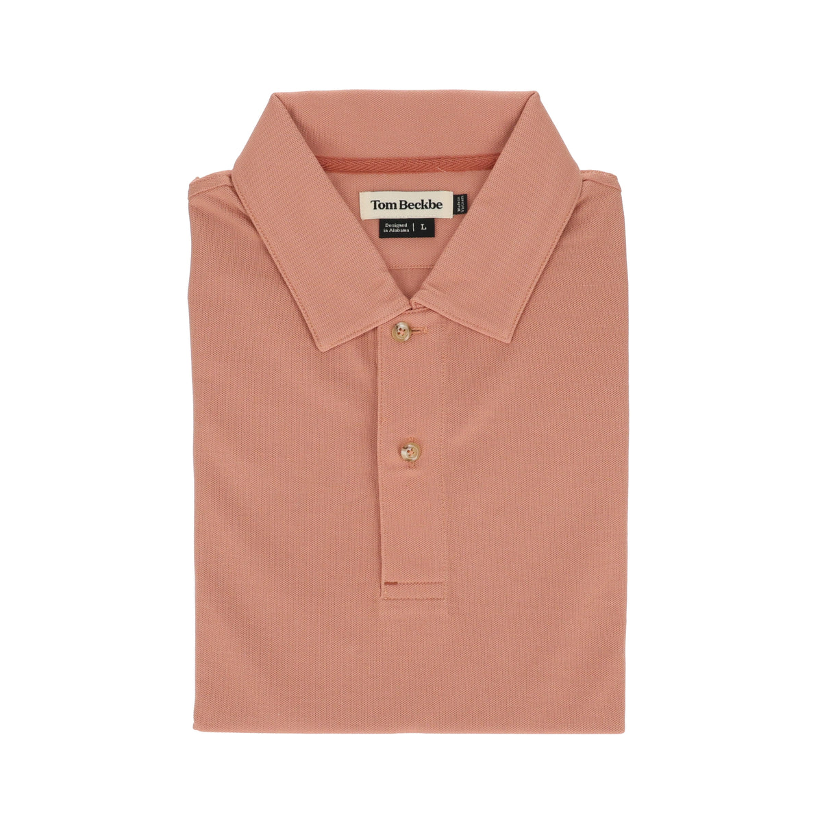 A folded Tom Beckbe Coastal Polo Shirt in peach, featuring a collar, three buttons, and moisture-wicking fabric.