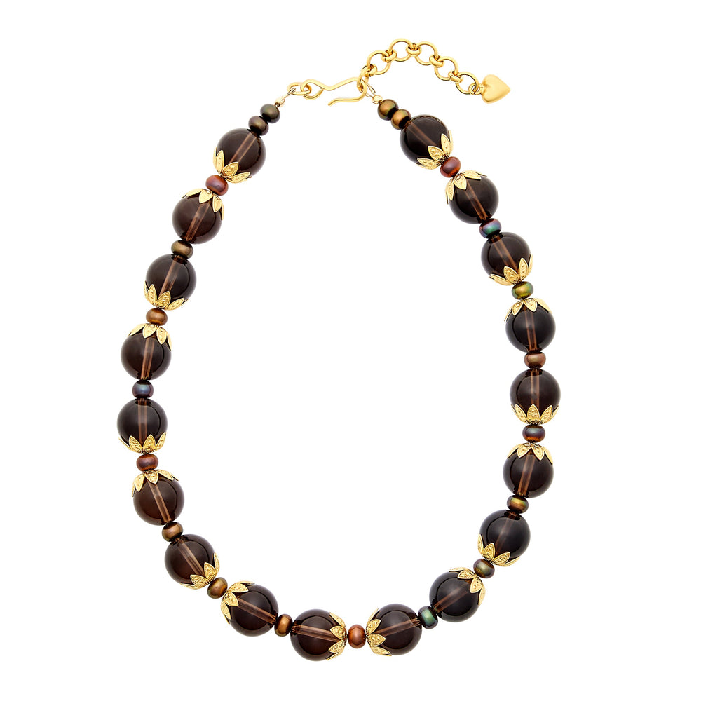 Top-down view of Tommie Necklace showcasing smoky quartz beads, pearls, and gold floral bead caps on white background