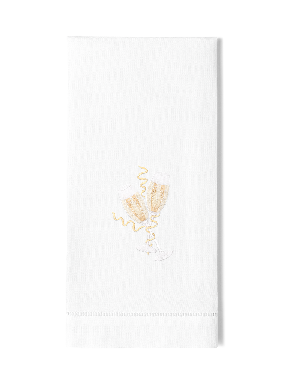 A white hand towel with a hemstitch. Two toasting champagne glasses are embroidered in the center.