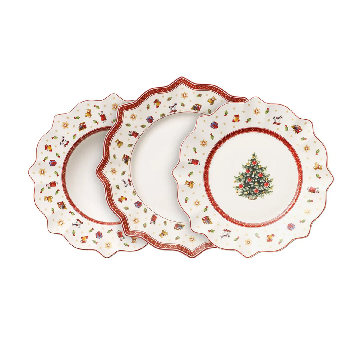 Overhead of Toys Delight set of three scalloped porcelain plates with Christmas tree center and red-green toy border on white