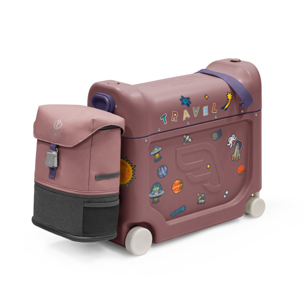 Three-quarter view of JetKids ride-on suitcase and backpack in hazy lilac showing space-themed stickers and white wheels on white background