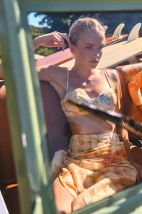 Bikini Top & Bikini Bottom in Still Life Symphony modeled in car in the sun.