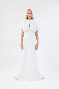 A model viewed from the front wearing a metallic white short-sleeve faux fur bridal bolero.
