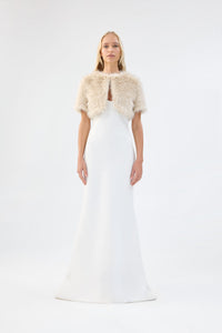A model viewed from the front wearing a metallic cream short-sleeve faux fur bridal bolero.