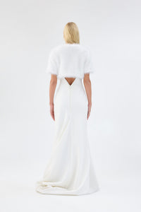 A model viewed from the back wearing a metallic white short-sleeve faux fur bridal bolero.