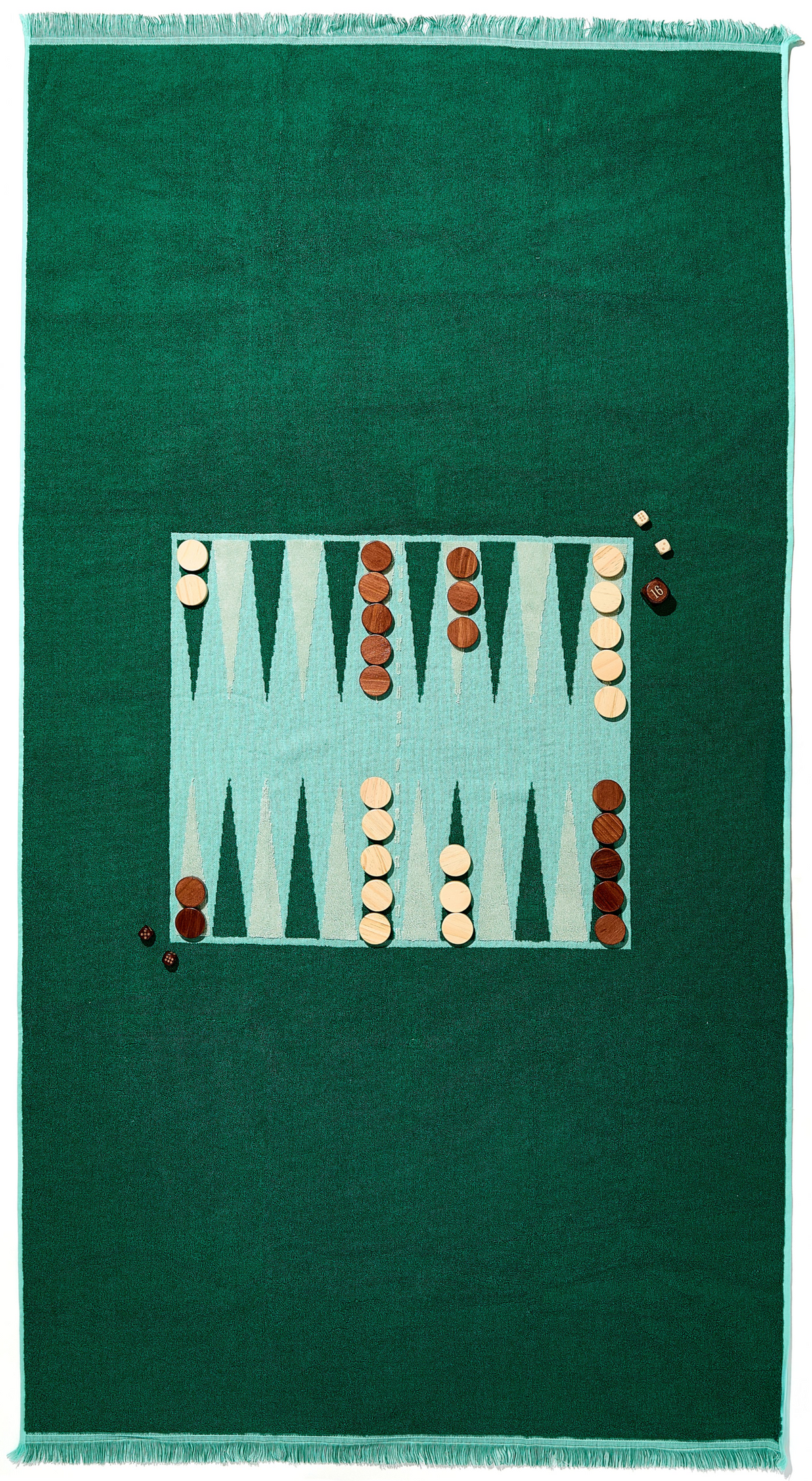Top-down view of Bali Beach Board towel showing regulation backgammon board print with dark and light wood pieces and fringe