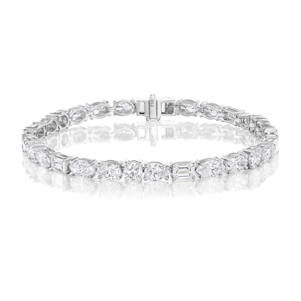 The Medium East-West Mixed Shape Diamond Tennis Bracelet in 18k white gold features alternating oval, marquise, emerald, and round diamonds, shown on a plain white background with a reflective surface.