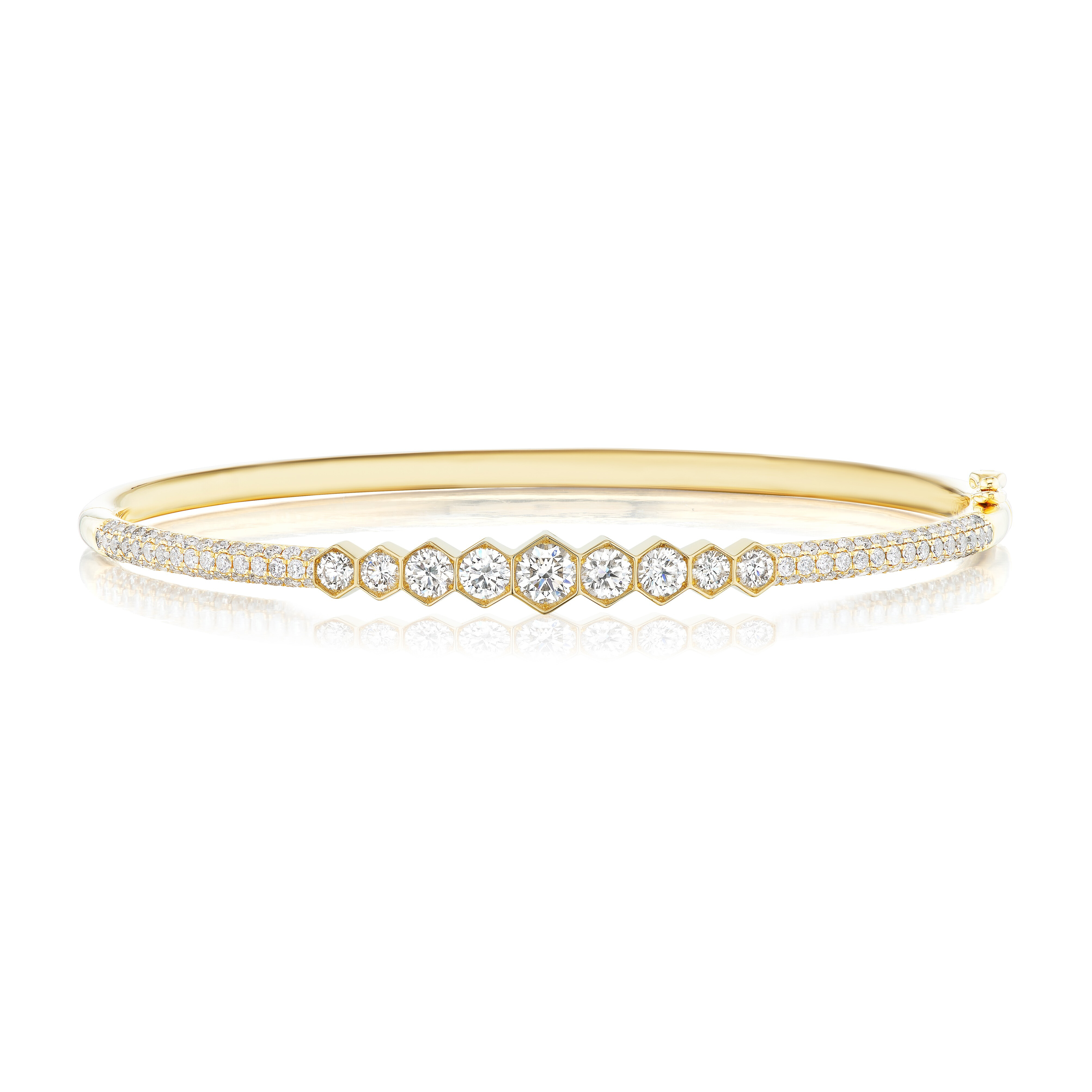 The Graduated Hexagon Bezel Set Diamond Pavé Bangle showcases a row of graduated SI clarity diamonds bezel set at the center, bordered by two pavé-set diamond rows on an elegant 18k gold band.