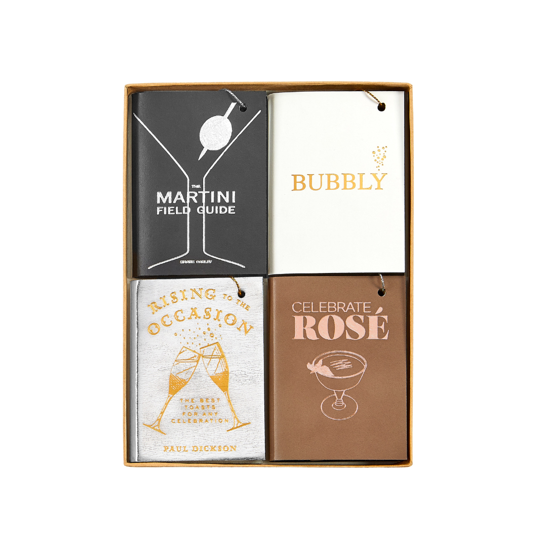 Top view of four mini leather book ornaments featuring Martini, Bubbly, Rising to the Occasion, and Celebrate Rosé covers