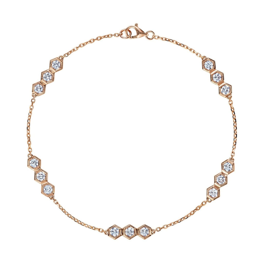 The Serpentine Station Bracelet with Hexagon Diamond Trios features clusters of round brilliant diamonds in 18k gold hexagonal settings, evenly spaced along the chain and secured with a lobster clasp.