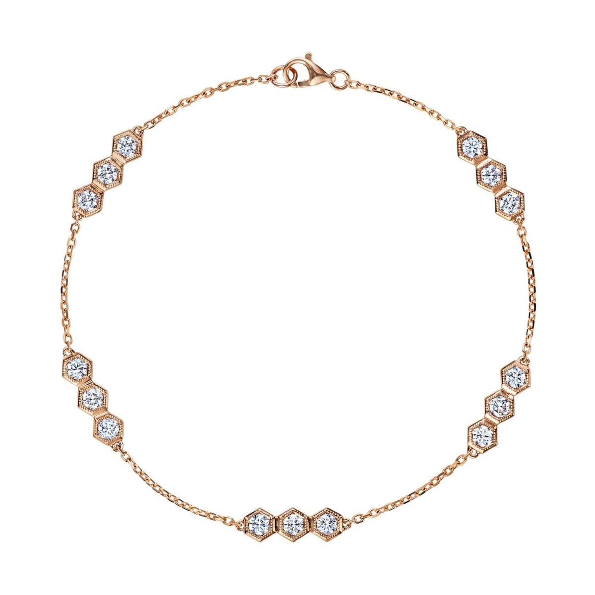 The Serpentine Station Bracelet with Hexagon Diamond Trios features clusters of round brilliant diamonds in 18k gold hexagonal settings, evenly spaced along the chain and secured with a lobster clasp.