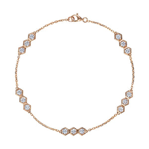 The Serpentine Station Bracelet with Hexagon Diamond Trios features clusters of round brilliant diamonds in 18k gold hexagonal settings, evenly spaced along the chain and secured with a lobster clasp.