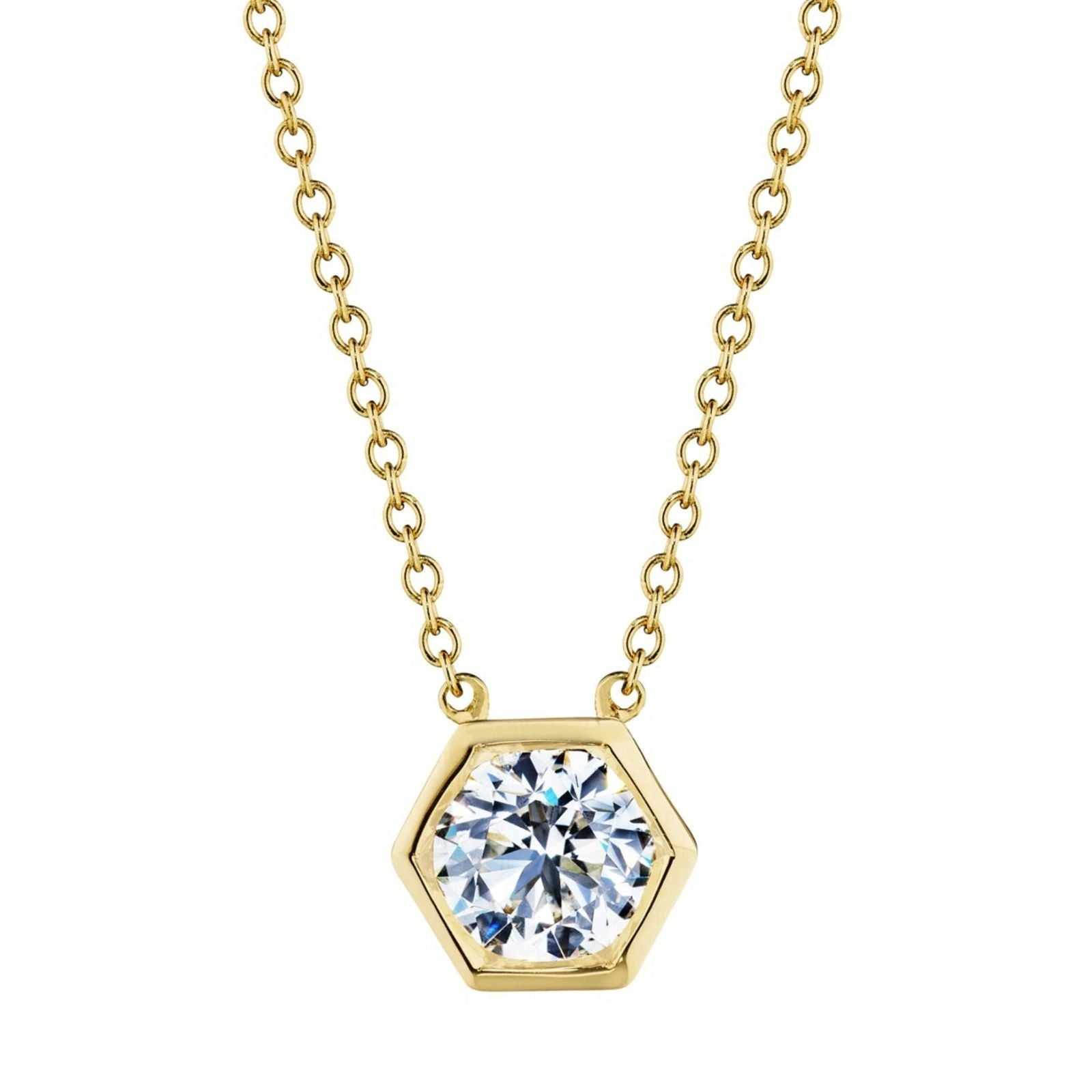 The Hexagon Bezel Set Round Brilliant Diamond Pendant features a gold chain and a hexagon pendant with a large, round, bezel-set diamond at its center—modern elegance inspired by the classic solitaire look.