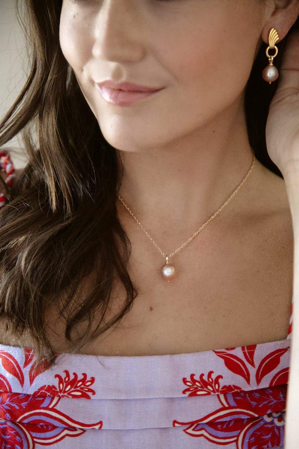 Close-up of Uptown Necklace on model showcasing 14/20 gold-filled double rope chain with a freshwater pearl against a soft background