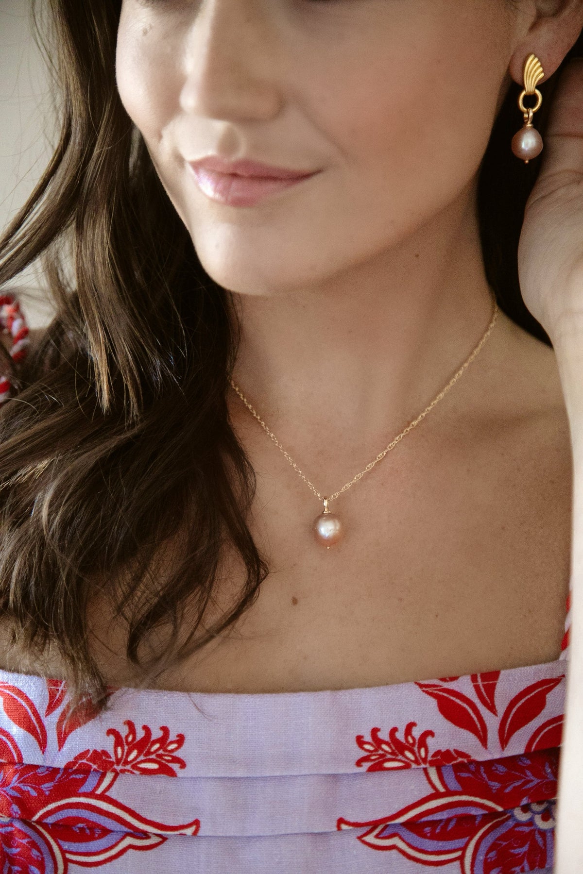 Close-up of Uptown Necklace on model showcasing 14/20 gold-filled double rope chain with a freshwater pearl against a soft background