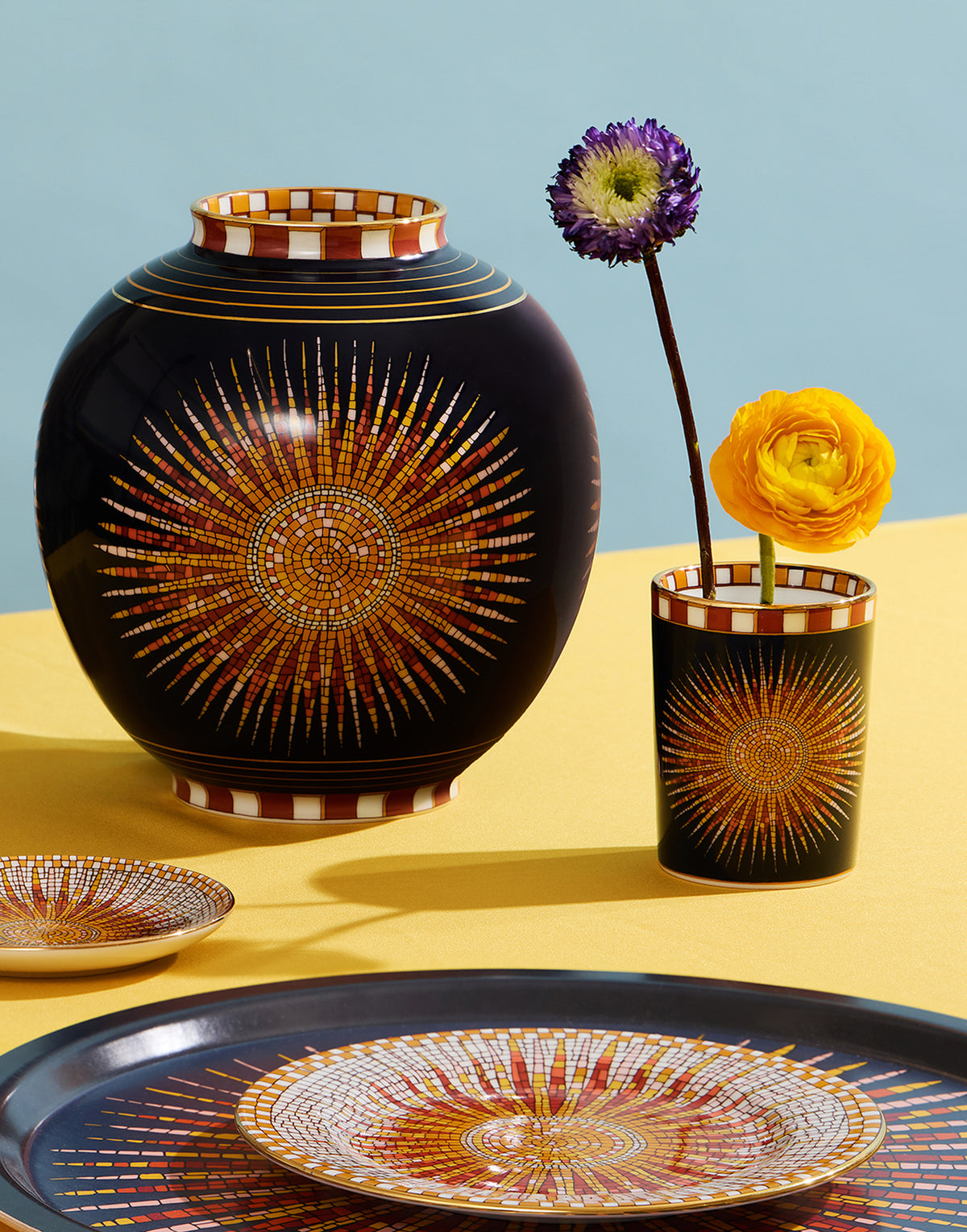 Front view of Decorative Cup in Sunrays Midnight showcasing its mosaic sunray pattern and gold trim with flowers