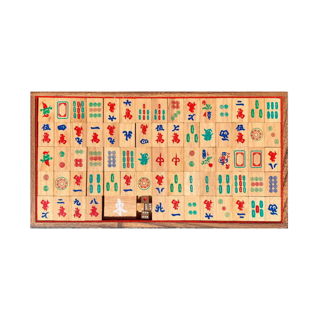 Top down view of Chinese mahjong set with handmade wooden tiles in wooden box on white background