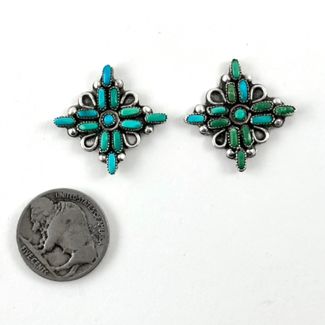 Front view of Pretty Vintage Petit Point Earrings showcasing turquoise and green floral designs with a coin for scale