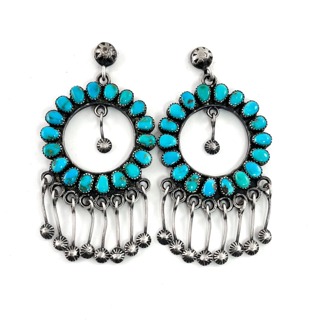 Front view of vintage hoop earrings showcasing American turquoise stones, sterling silver and dangling star studs on white background