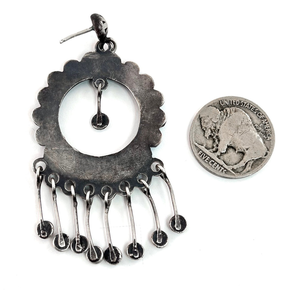Close-up of Vintage Hoop Earrings showcasing scalloped silver, turquoise, and dangling star studs with a coin for scale