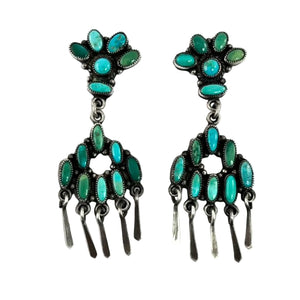 Front view of vintage Zuni earrings showcasing American turquoise set in sterling silver on a white background
