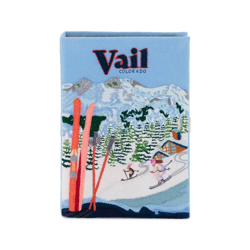 Front view of Vail Book Clutch showing embroidered Vail Colorado logo and ski scene with red skis on blue background