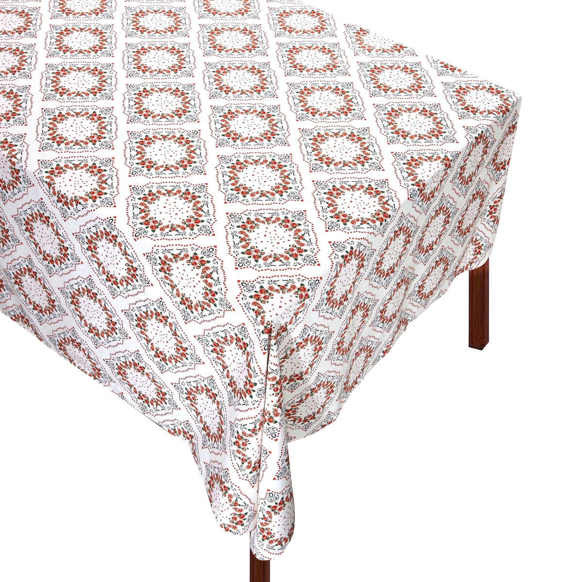 Angled view of Pink Scarf Tablecloth showcasing elegant scarves of hearts and flowers on a table against a white background