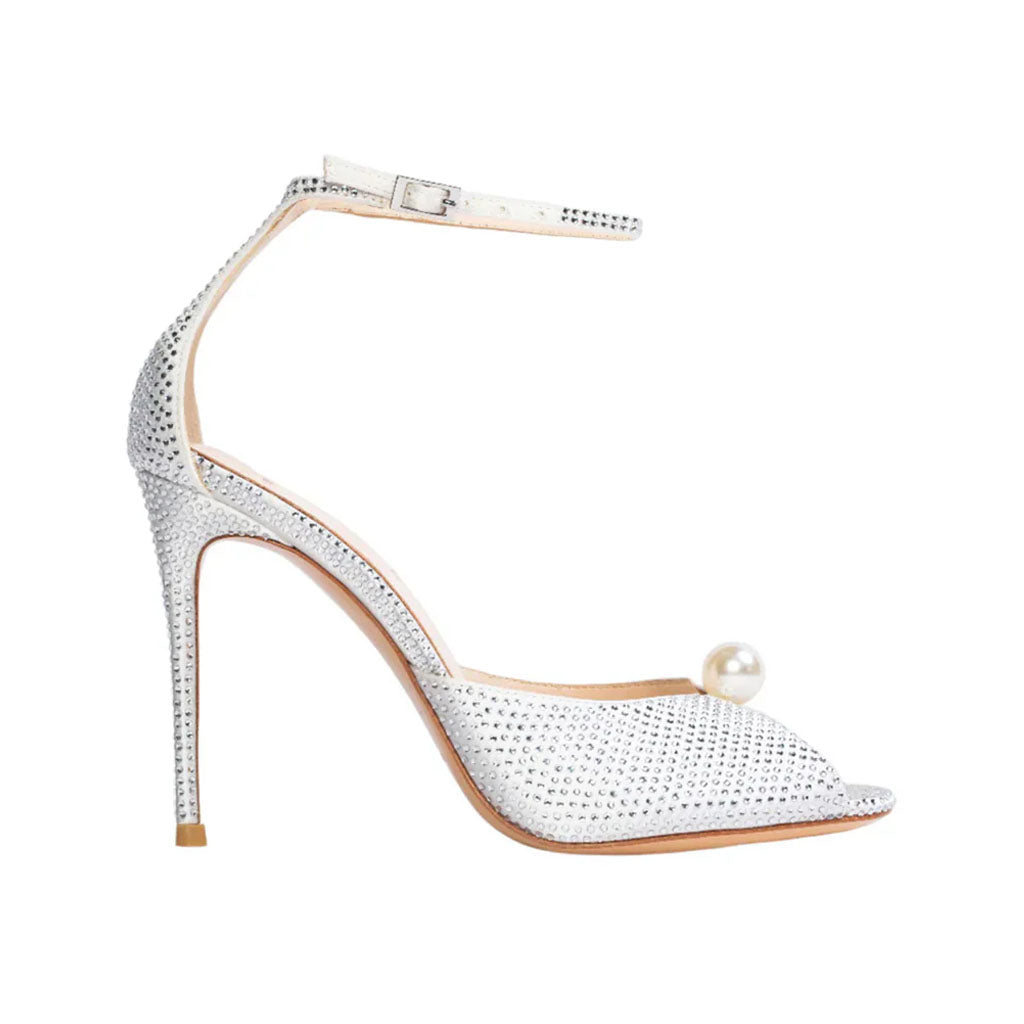Side view of Veda 100 in White Satin sandal showcasing pearl detailing and stiletto pin heel with white background