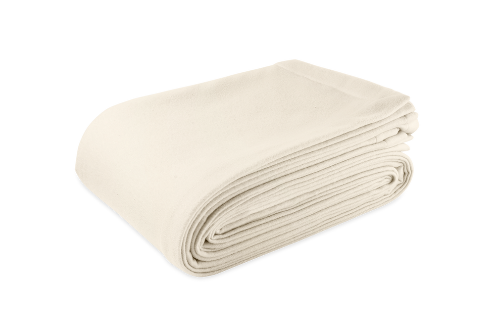Three quarter view of Venus blanket folded to show soft plush texture in ivory on a white background