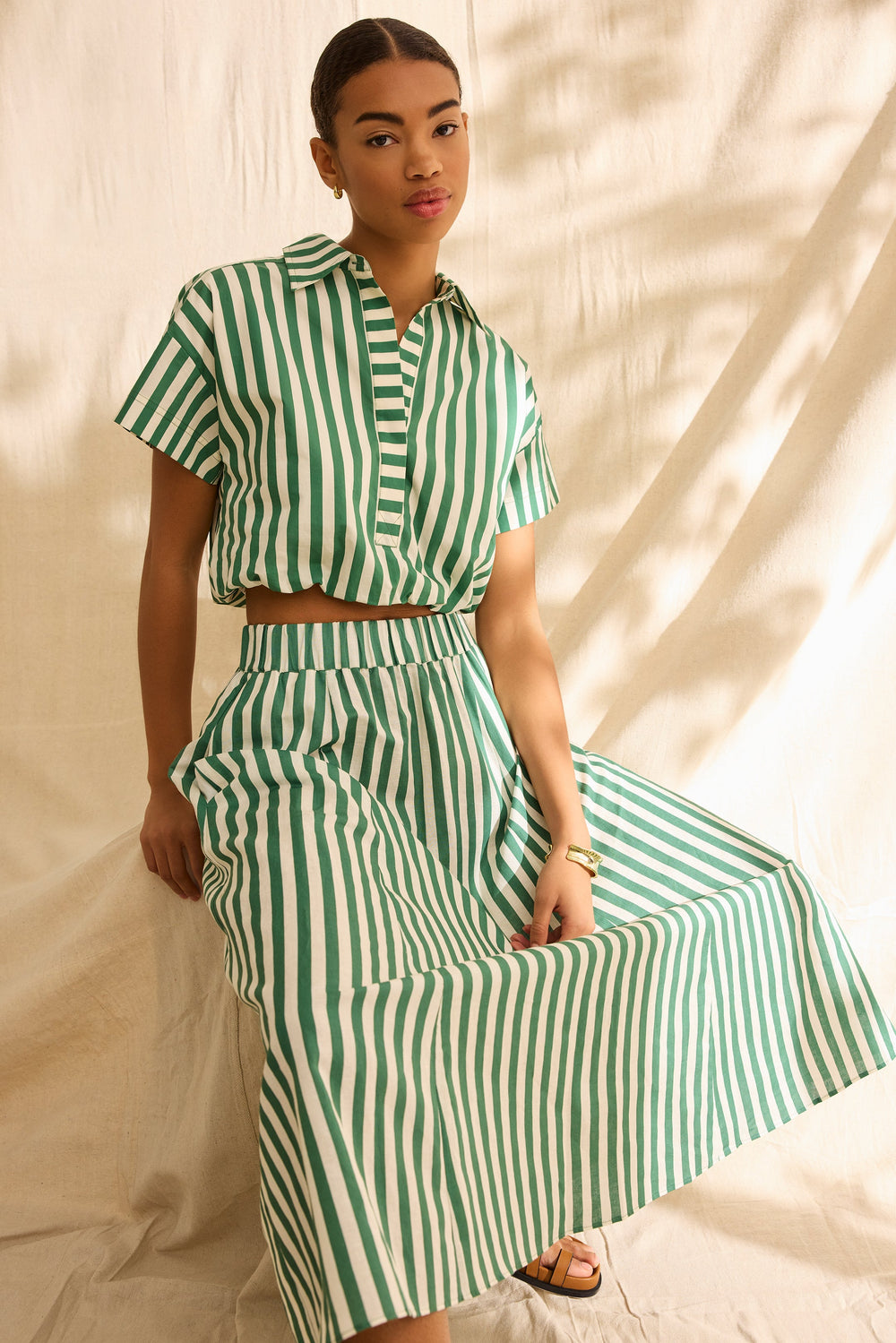 Green and white striped midi skirt with pockets and an elastic waistband 