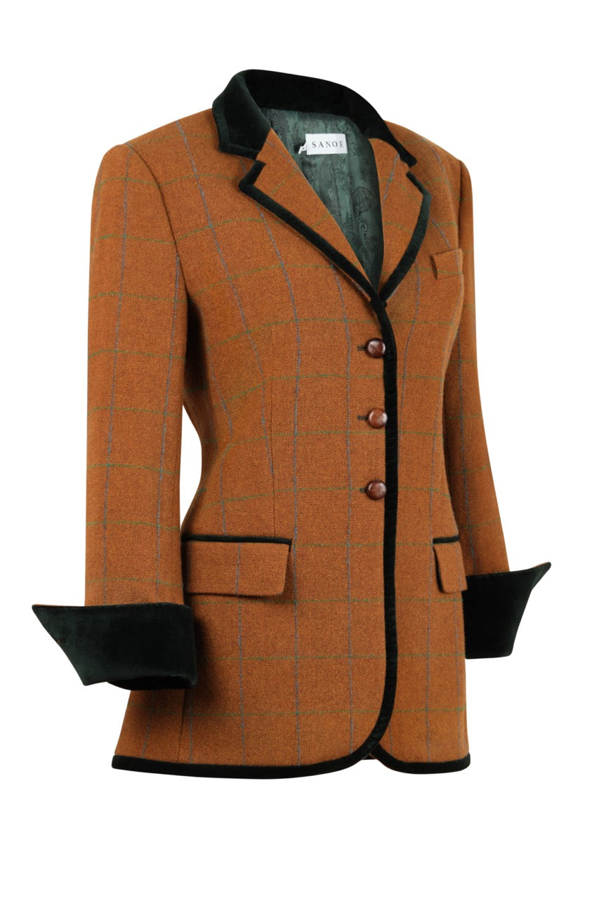 Three-quarter view of Victoria Windsor checked wool blazer with black velvet trim, turn-back cuffs, and three wooden buttons on white background