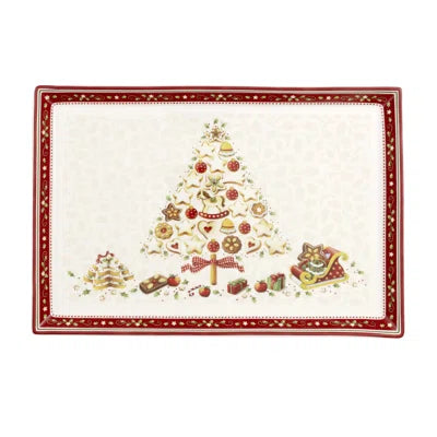 Top down view of Winter Bakery Delight rectangular cake plate showcasing central decorated Christmas tree motif and scalloped red edge on white background