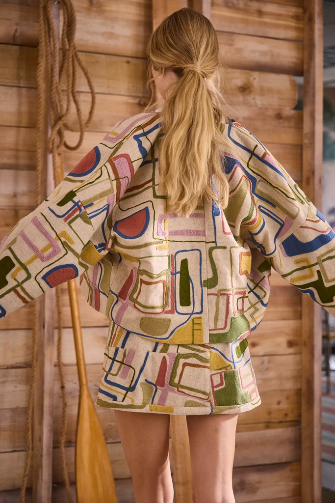 Throw-on jacket with curved, open front, and dolman sleeves.