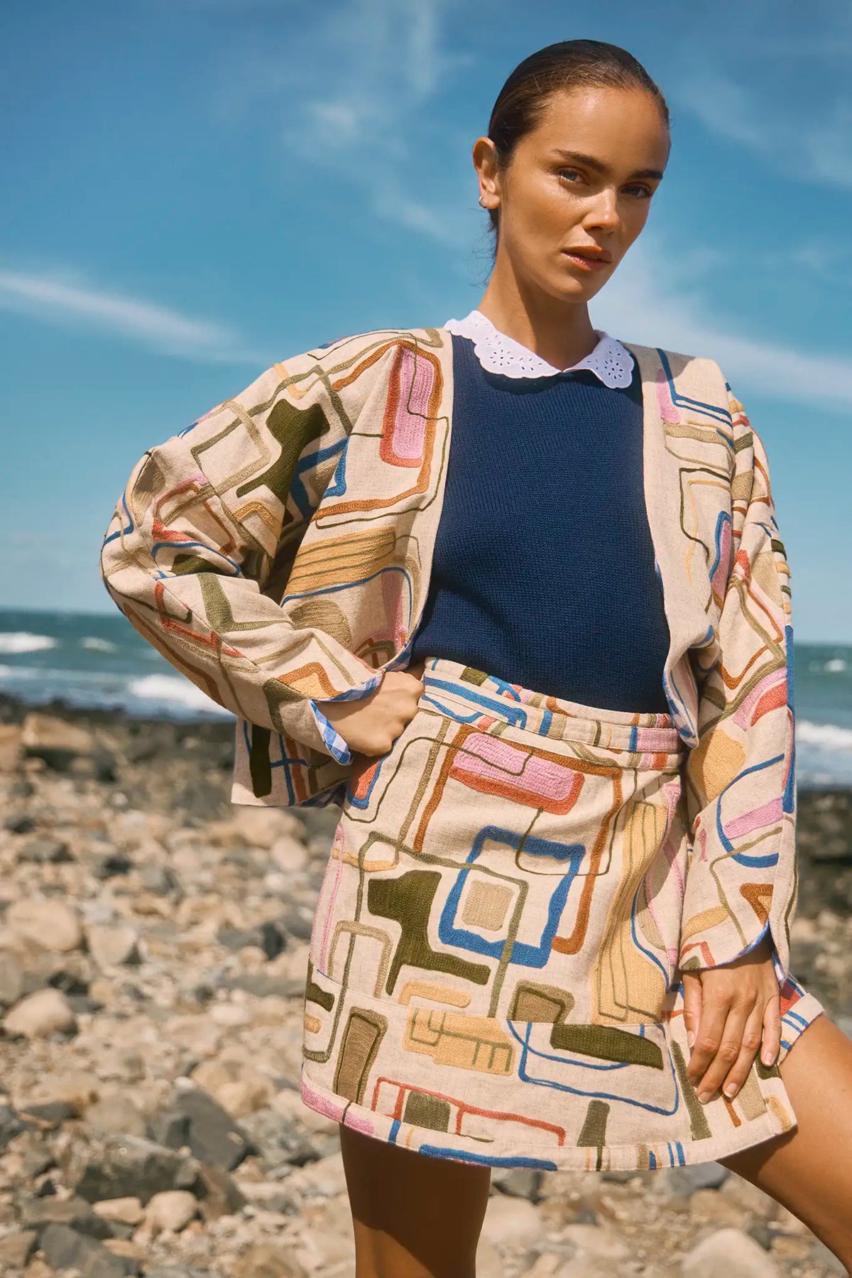 Throw-on jacket with curved, open front, and dolman sleeves.