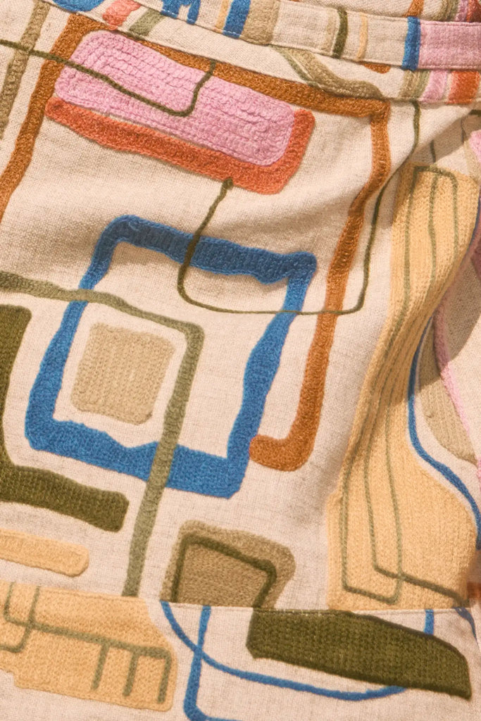 Skirt with a banded waist and sleek wrap silhouette with discreet snap closure.