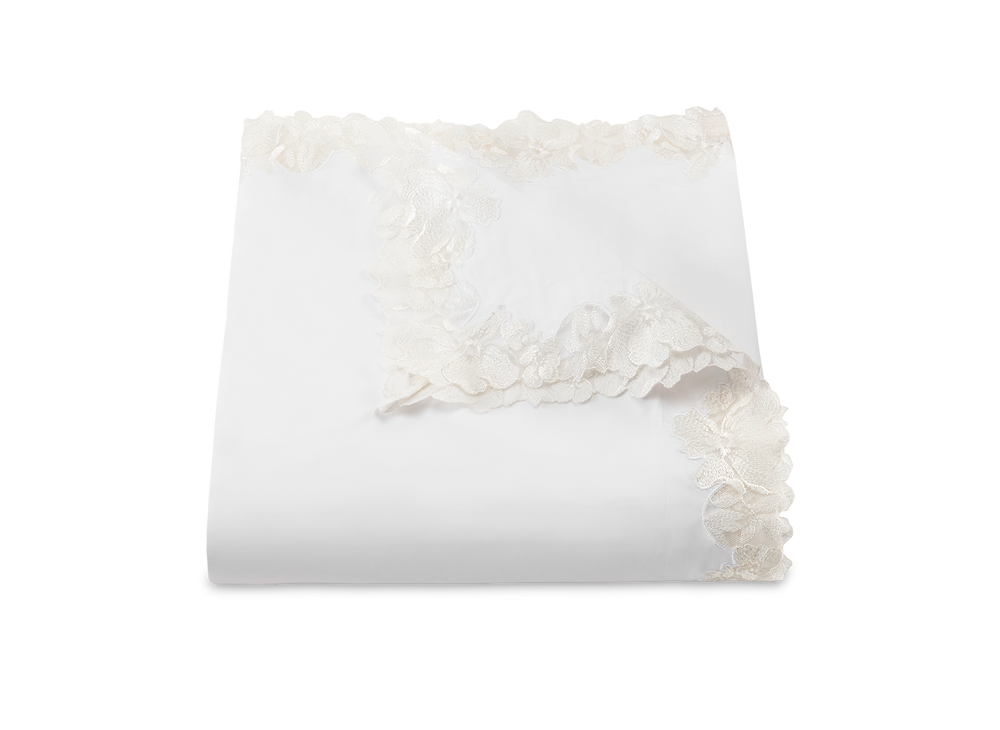 Folded Virginia duvet cover in white showing scalloped floral lace trim on a white background