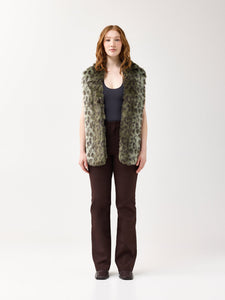 Woman wearing a green leopard faux fur scarf on a white background