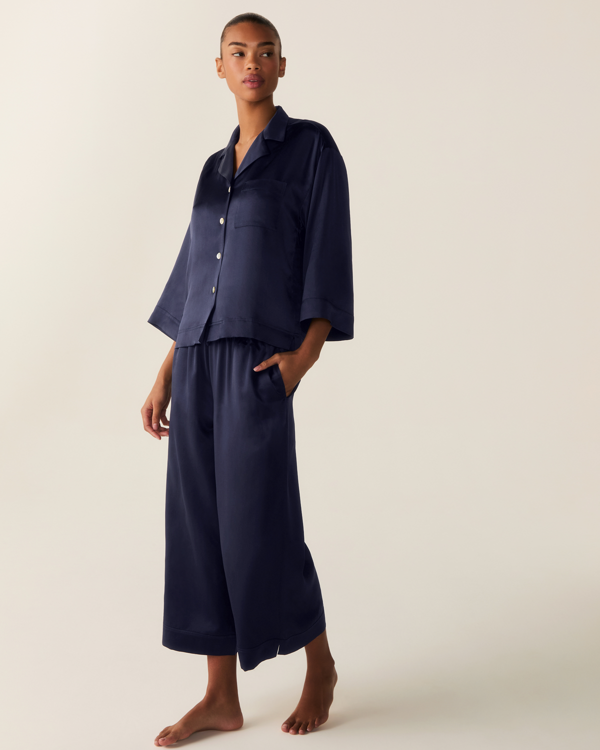 Front view of Olivia Wide Leg Silk Pajama Set in Navy with three-quarter sleeves and wide-leg trousers on a model