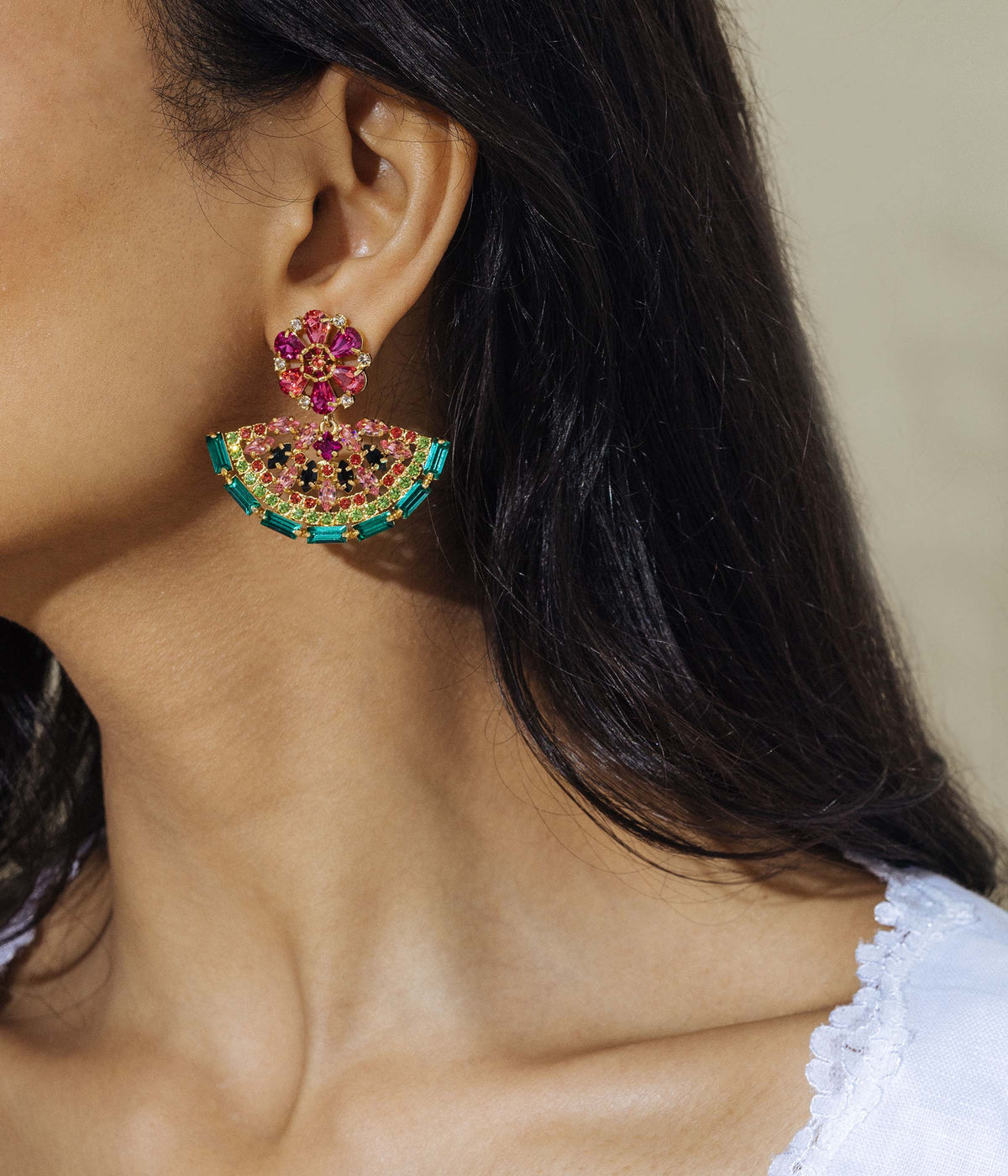 Close-up side view of Watermelon Slice Earrings showcasing a jeweled watermelon design on a model’s ear with dark hair